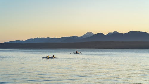 Two Men in Kayaks Out at Sea