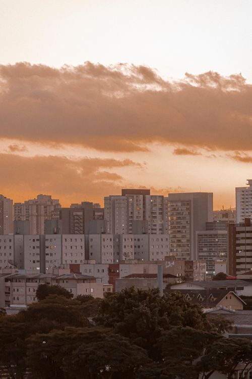 Free Aerial view of modern urban skyline at sunset, showcasing high-rise buildings and vibrant city architecture. Stock Photo