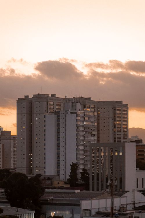 Free A serene cityscape image featuring tall residential buildings at sunrise. Stock Photo