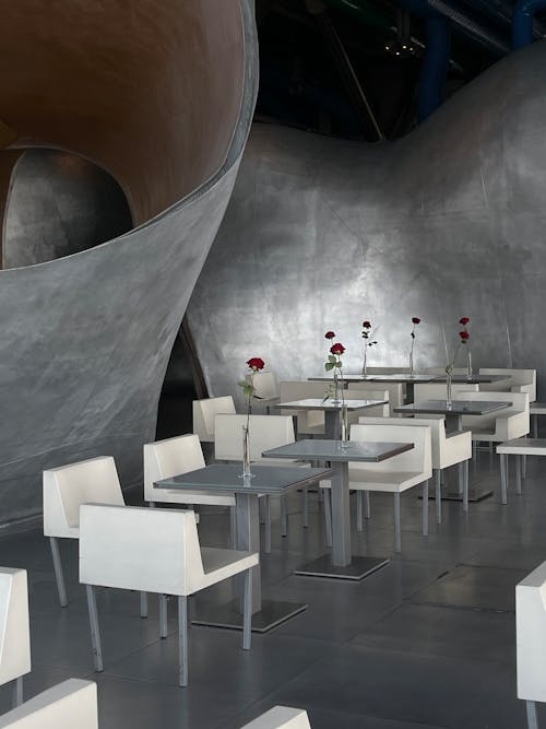 A restaurant with white tables and chairs