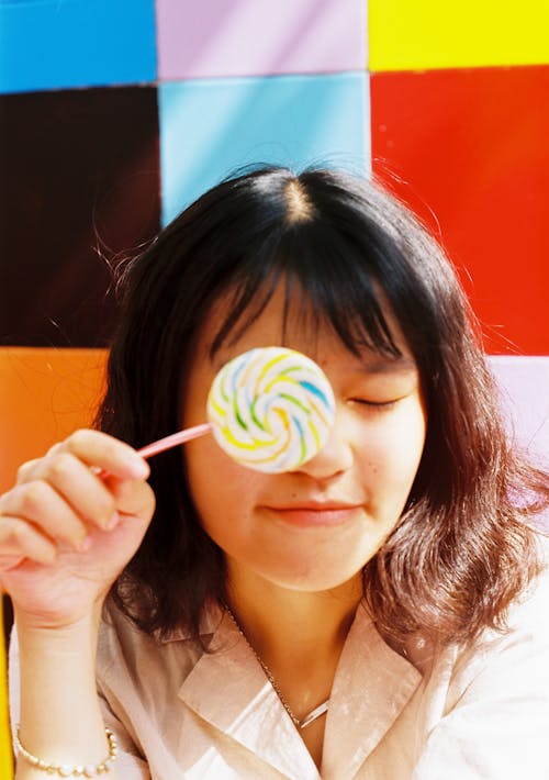Free Photo of Woman Holding Lollipop Stock Photo