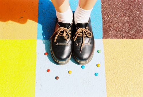 High-Angle Photo of Person Wearing Black Leather Shoes