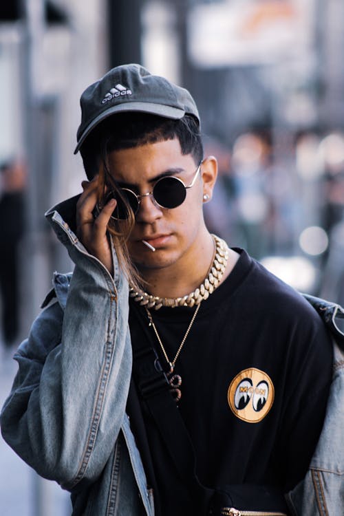 Portrait photo of man wearing grey Adidas fitted cap and  black sunglasses