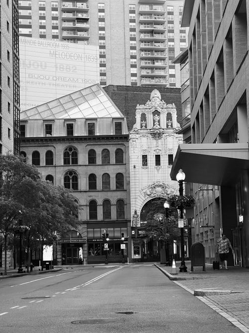 Free A monochrome view of an empty city street with historic and modern buildings. Stock Photo