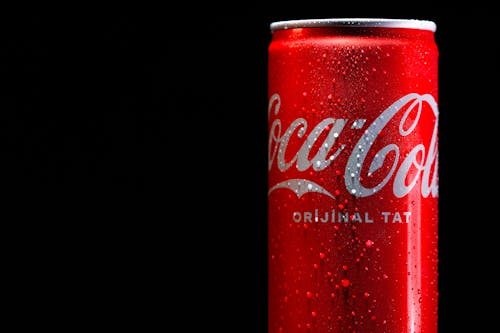 A can of coca cola on a black background