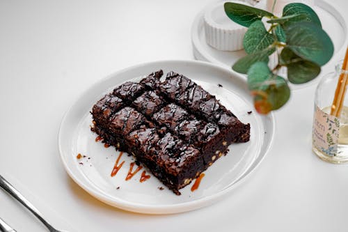 A plate with a brownie on it and a fork