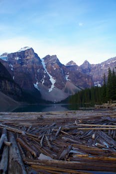 A stunning landscape of Moraine Lake surrounded by snowy mountains and lush forests.