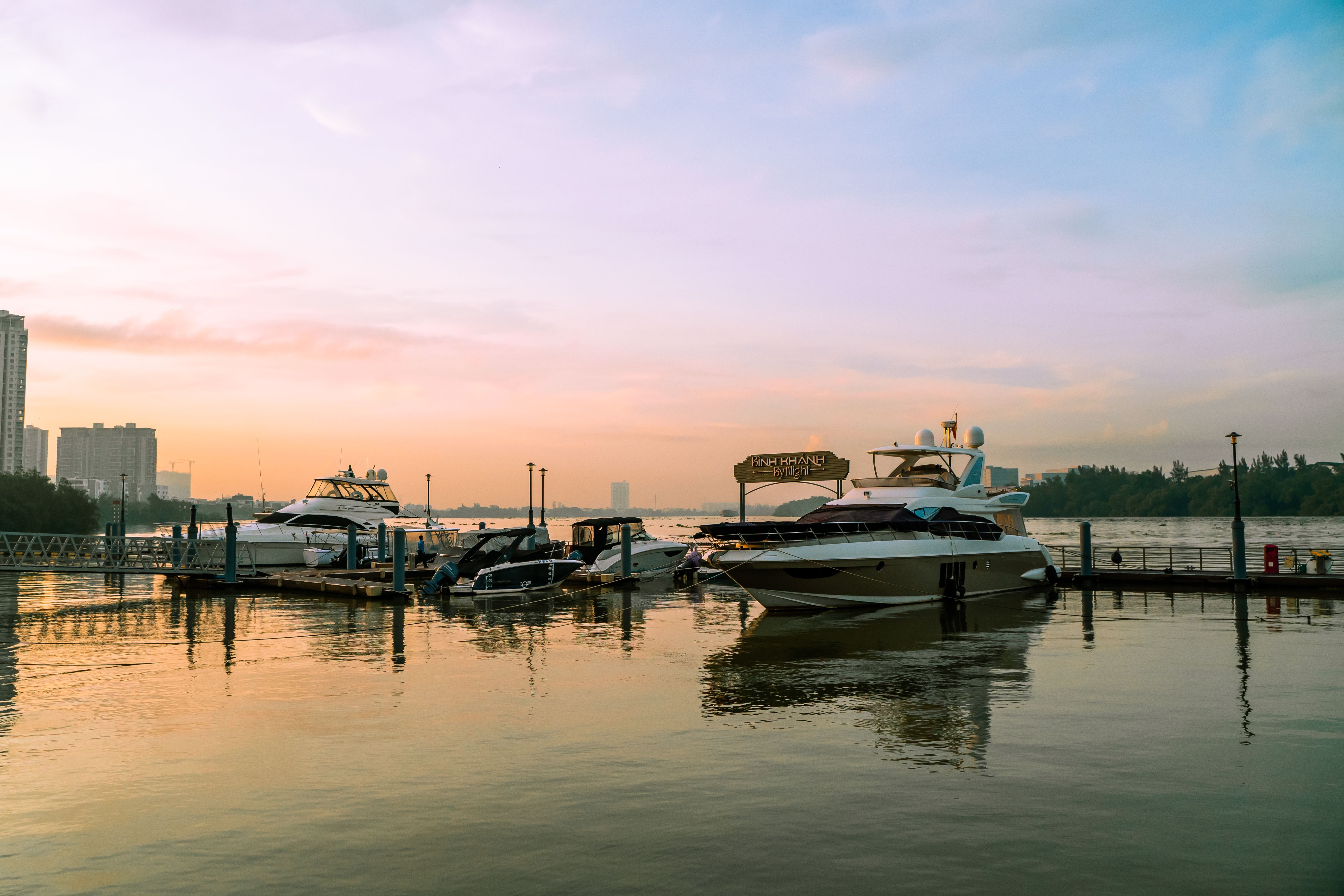 Serene sunset view of yachts docked at a marina on Saigon River, Ho Chi Minh City, Vietnam.