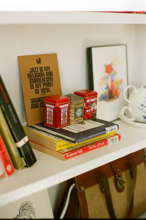 A shelf with books and tea bags on it