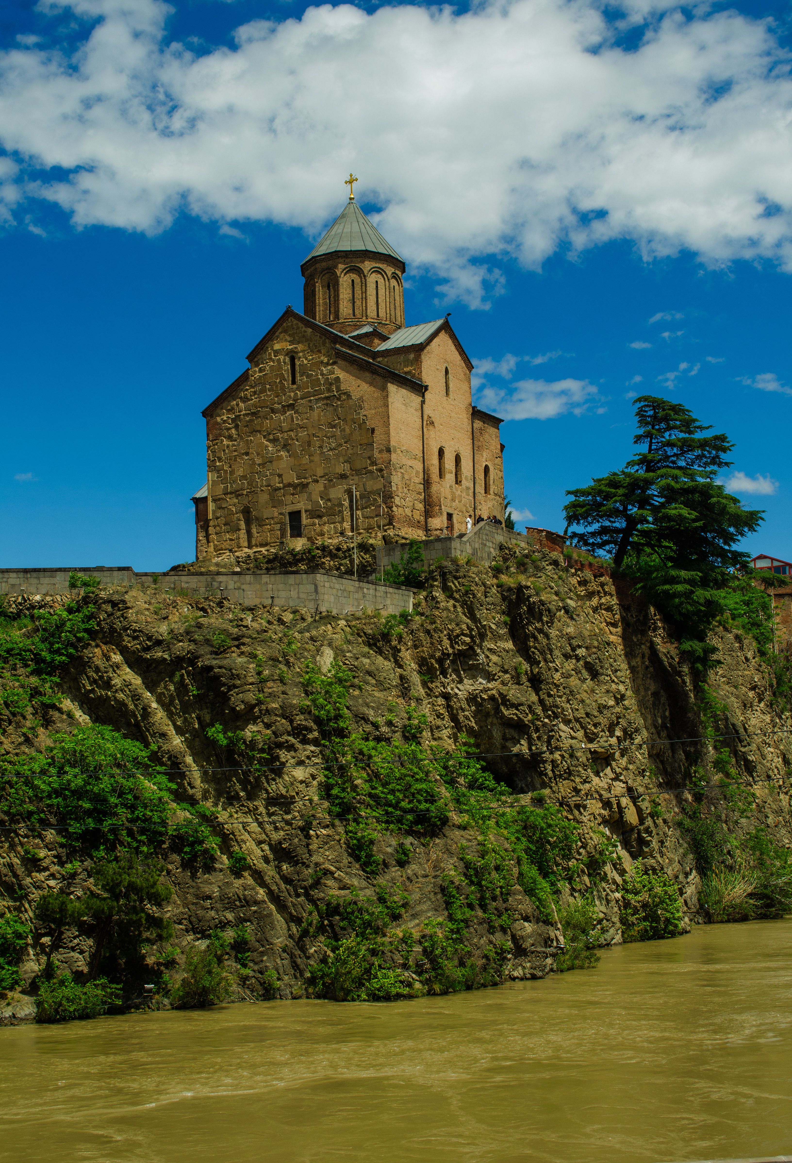 A church on top of a cliff overlooking a river · Free Stock Photo