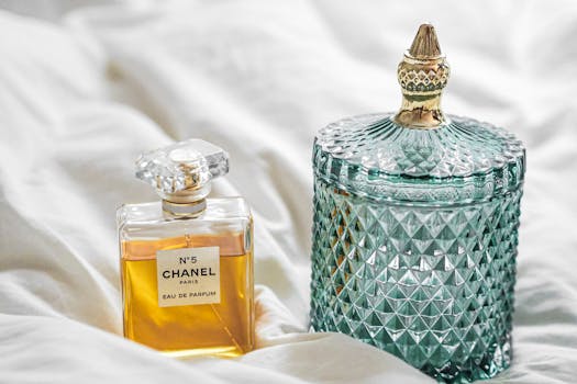 Luxurious Chanel No. 5 perfume beside an elegant decorative glass jar.