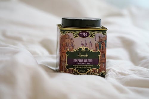 A jar of tea sitting on top of a bed