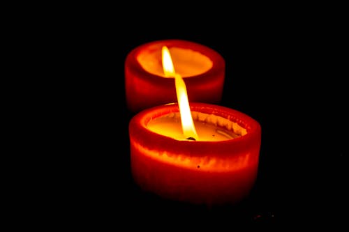 Close-up of Lit Candle over Black Background