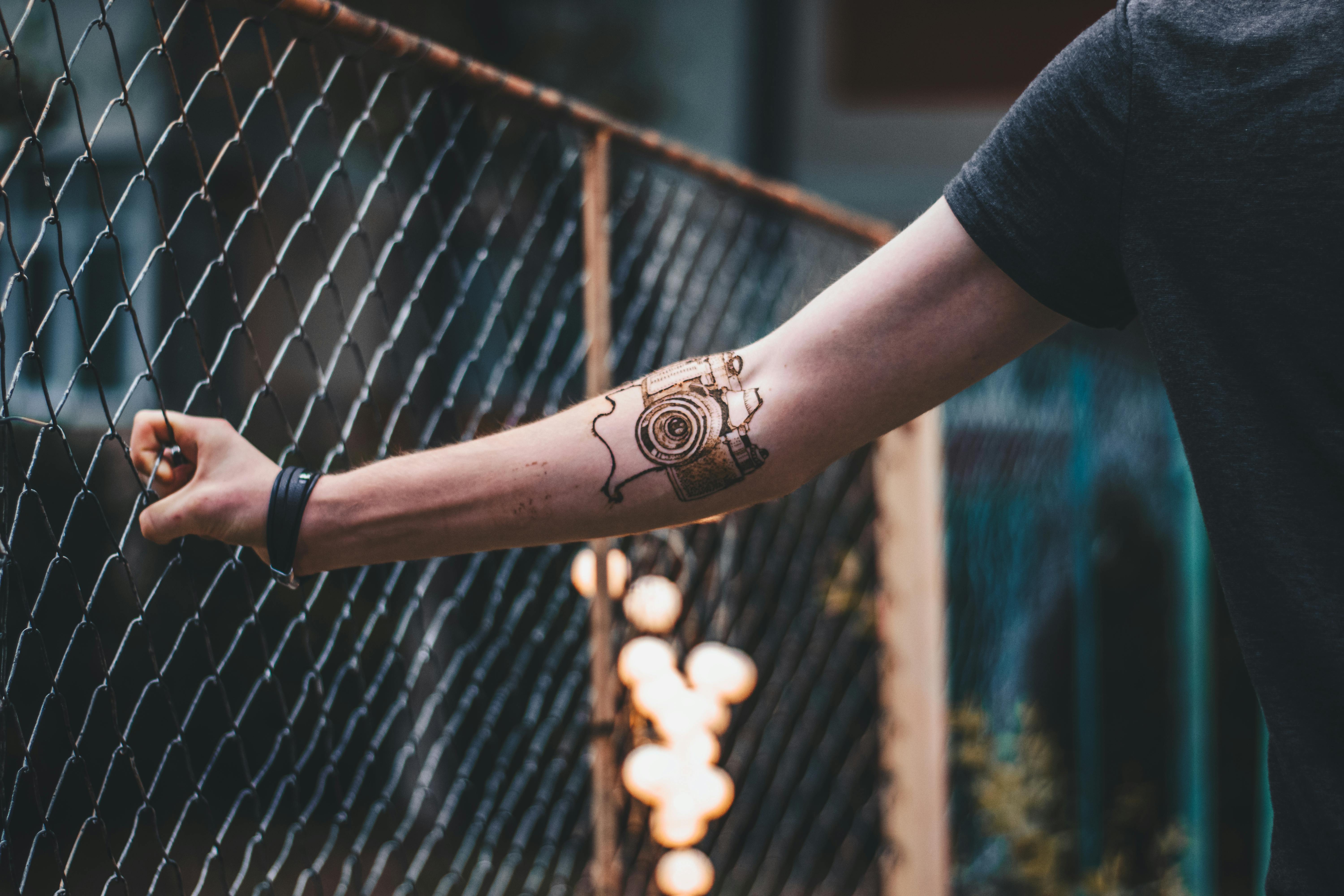 Skull behind a fence tattoo