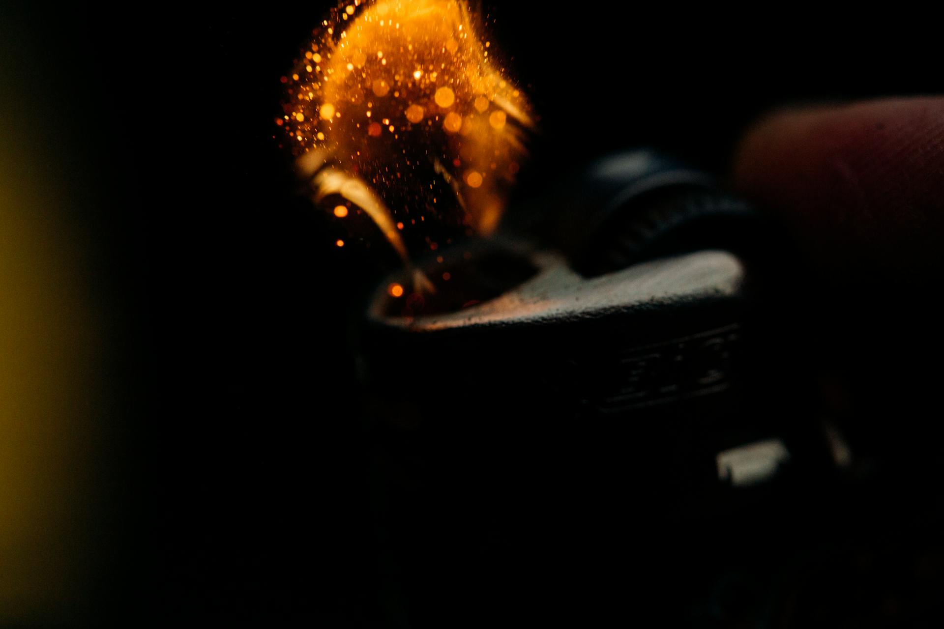 A detailed close-up of sparks igniting from a lighter, capturing the heat and fire ignition moment.