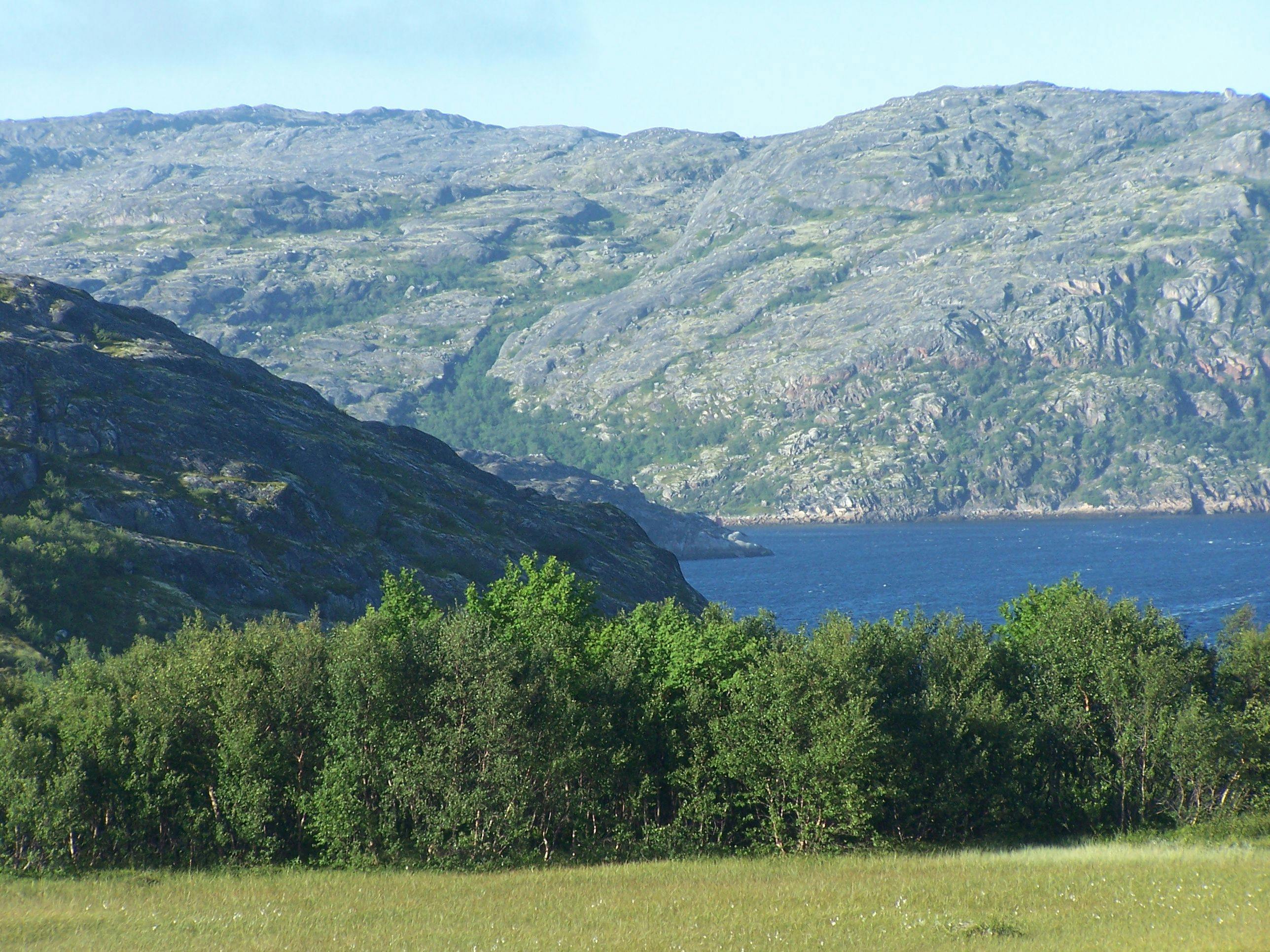 Scenic View of Lake Against Mountain Range