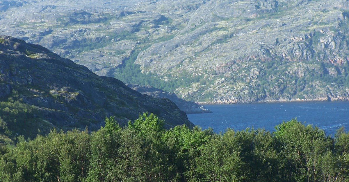 Scenic View of Lake Against Mountain Range
