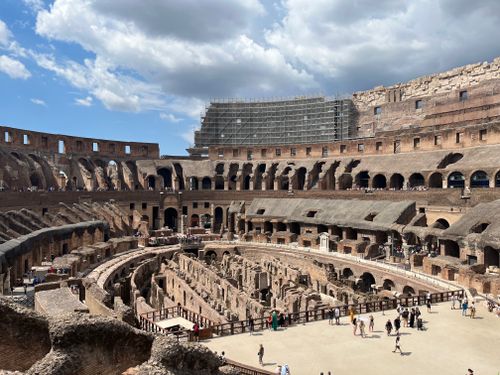 Free Explore the iconic Colosseum's interior in Rome with tourists highlighting the grandeur of ancient architecture. Stock Photo