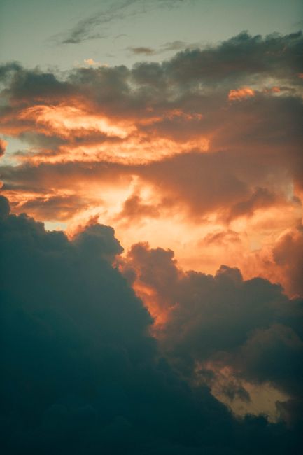 Stunning view of dramatic clouds illuminated by the golden hues of sunset for an atmospheric scene.