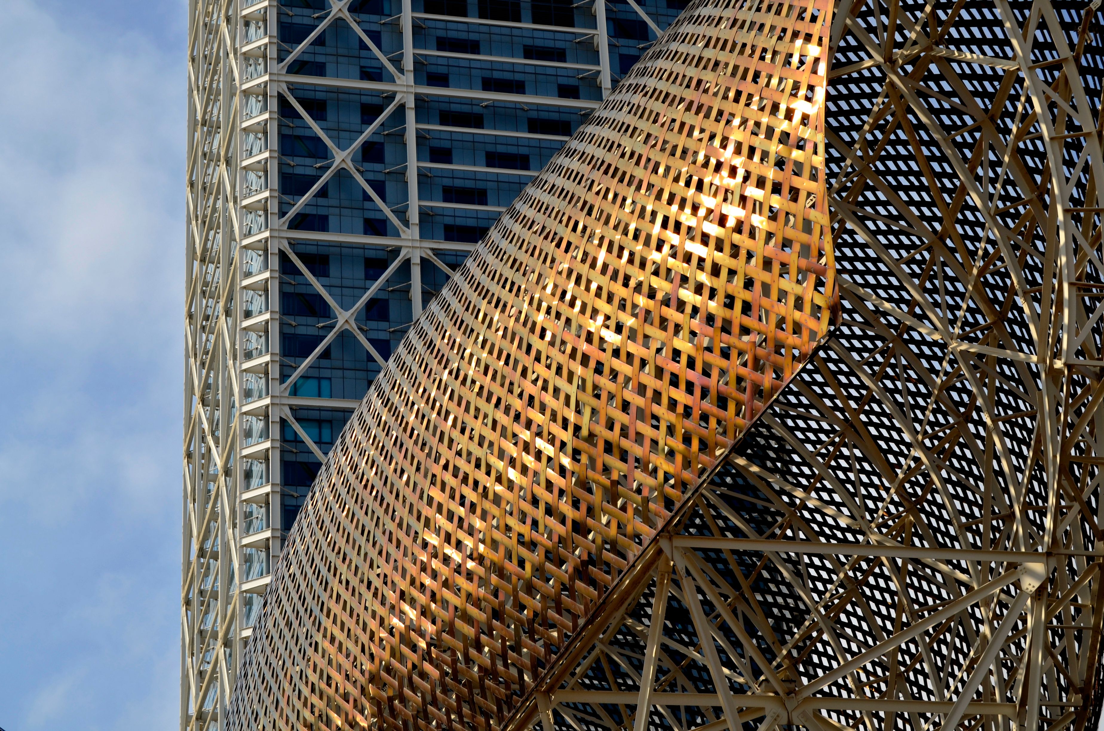 Golden Fish sculpture at Barcelona's coastline, a modern landmark and tourist attraction.