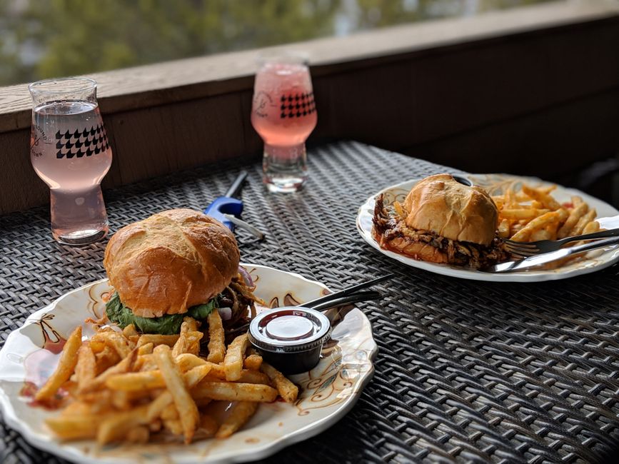 A casual restaurant table with plated lunch dishes and drinks