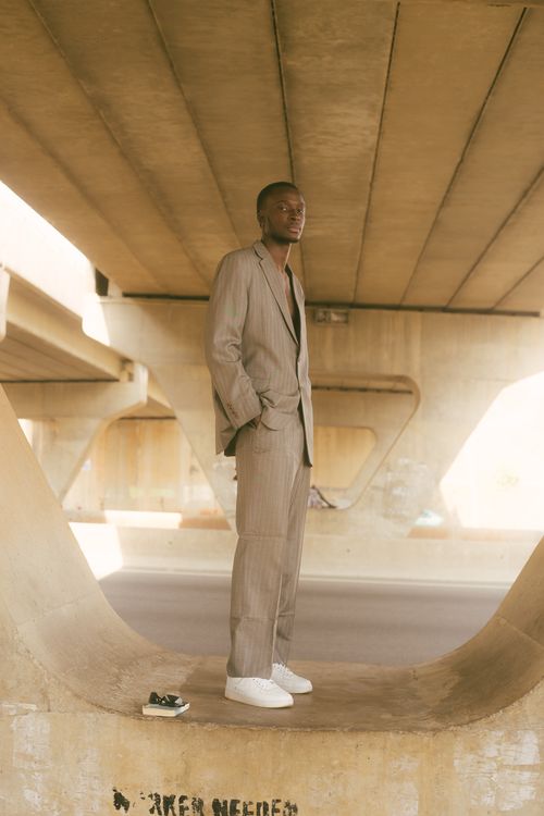 Man Posing in a Suit under a Bridge · Free Stock Photo