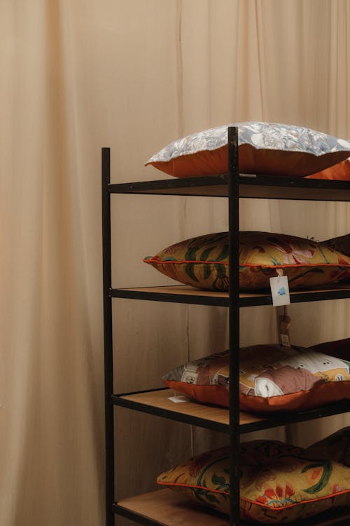 A shelf with several pillows on it