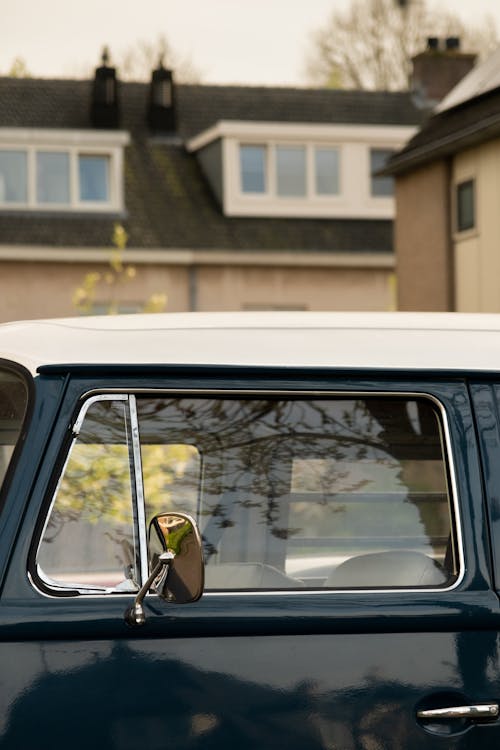 A blue and white van with a window open