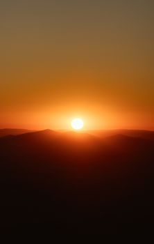Gorgeous sunset over the rolling dunes of Wadi Rum Desert in Jordan, capturing serene natural beauty.