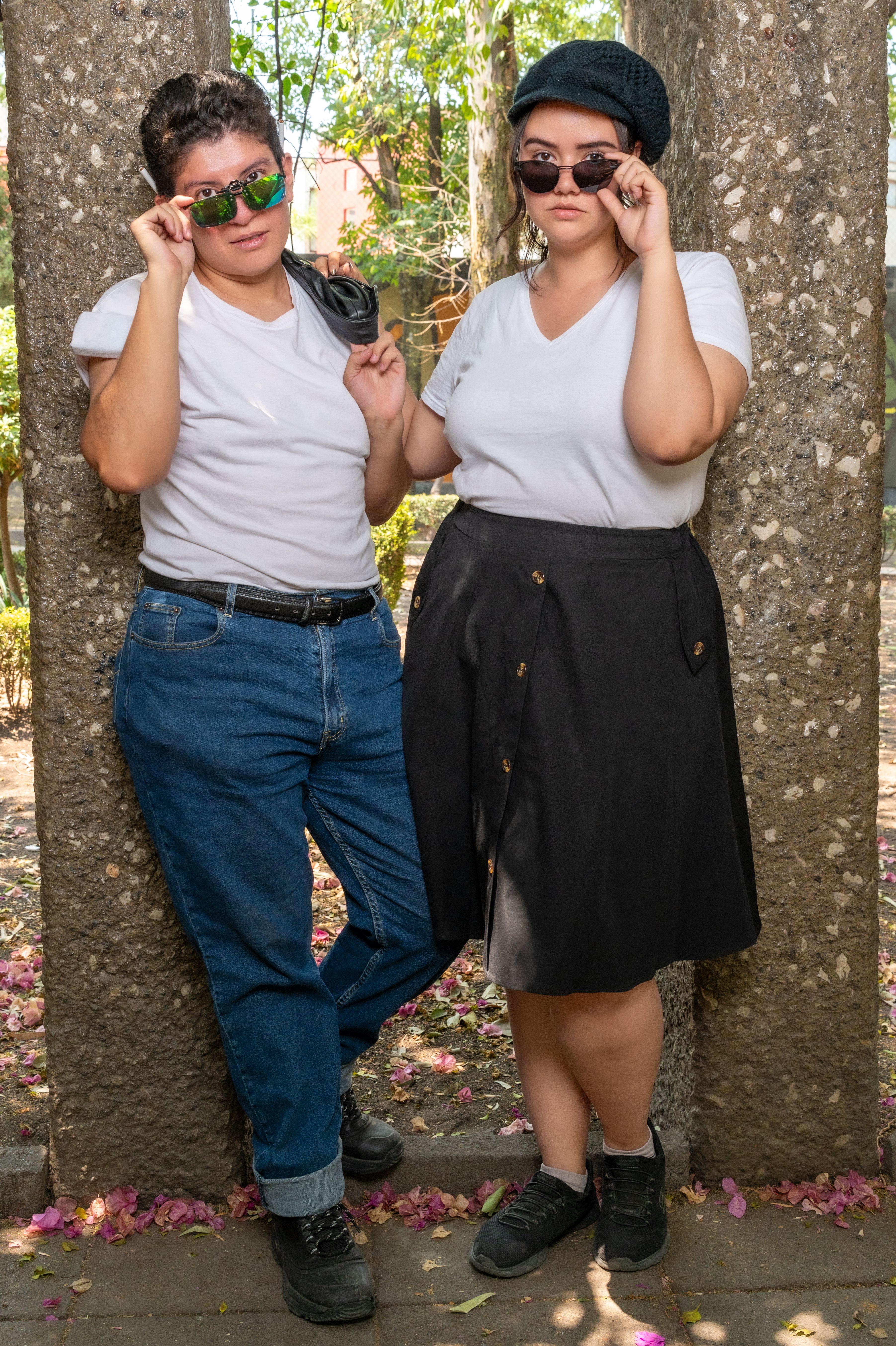 A Young Man and Woman in Casual Clothes and Sunglasses Standing Outside ...