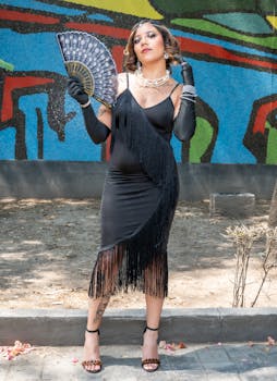 Elegant woman in a black dress, accessorized, posing outdoors in Mexico City.