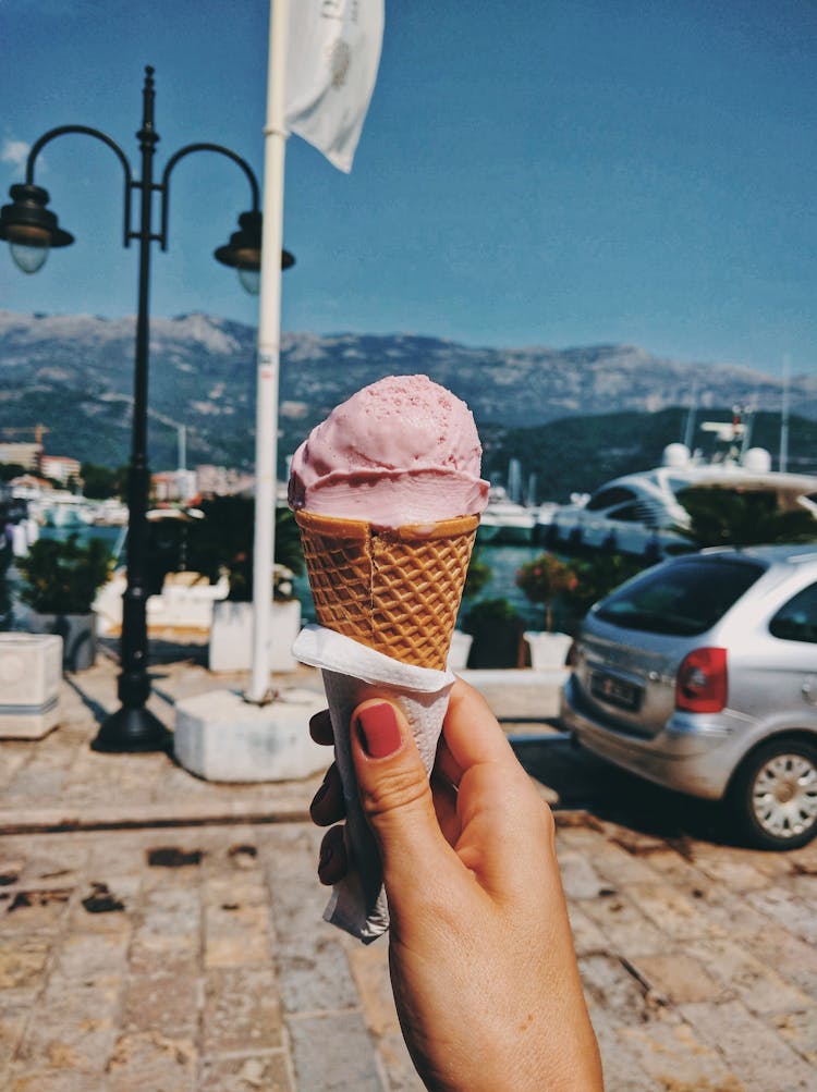 Person Holding An Ice Cream Cone