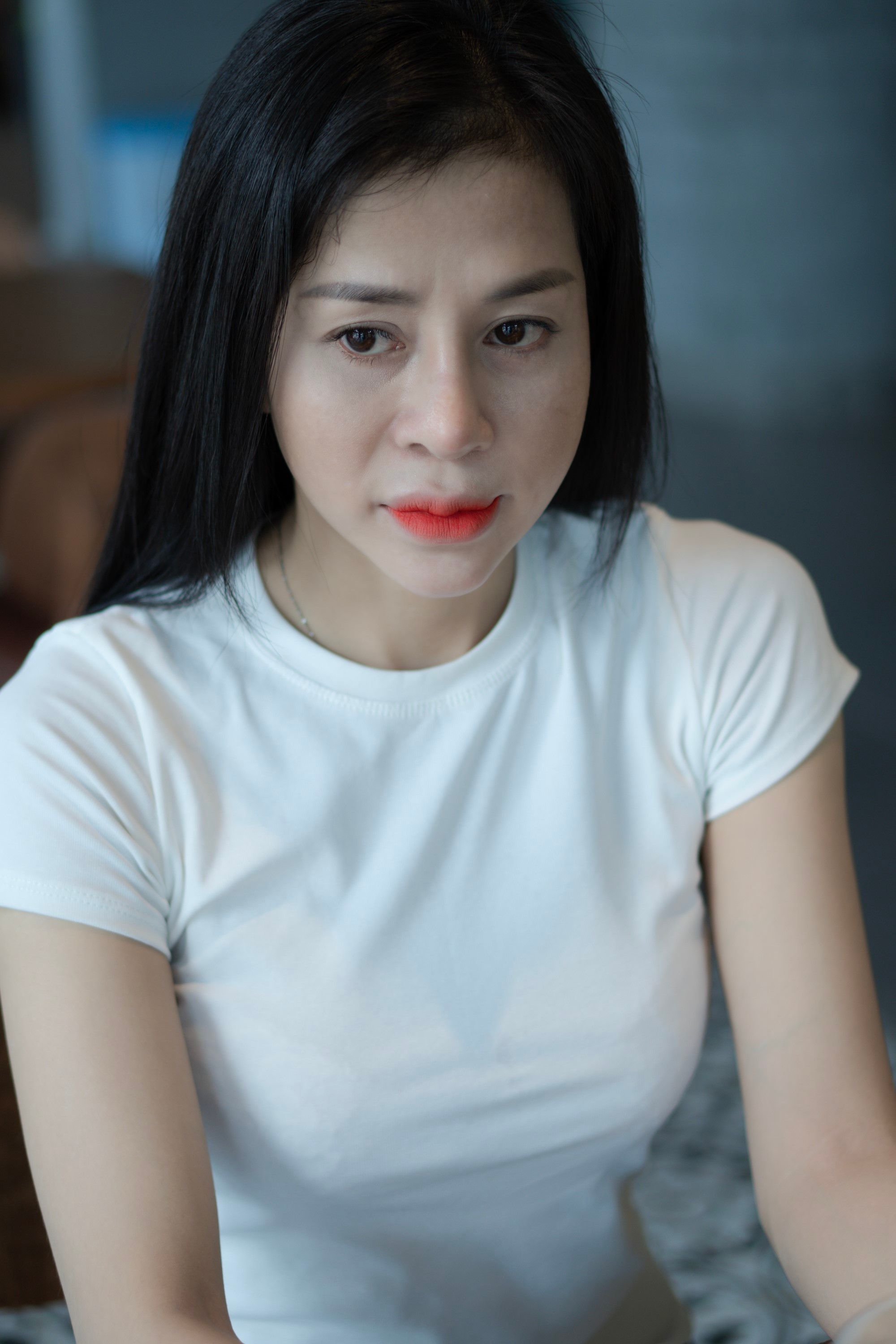 Photo of a Young Woman Wearing a White T-shirt