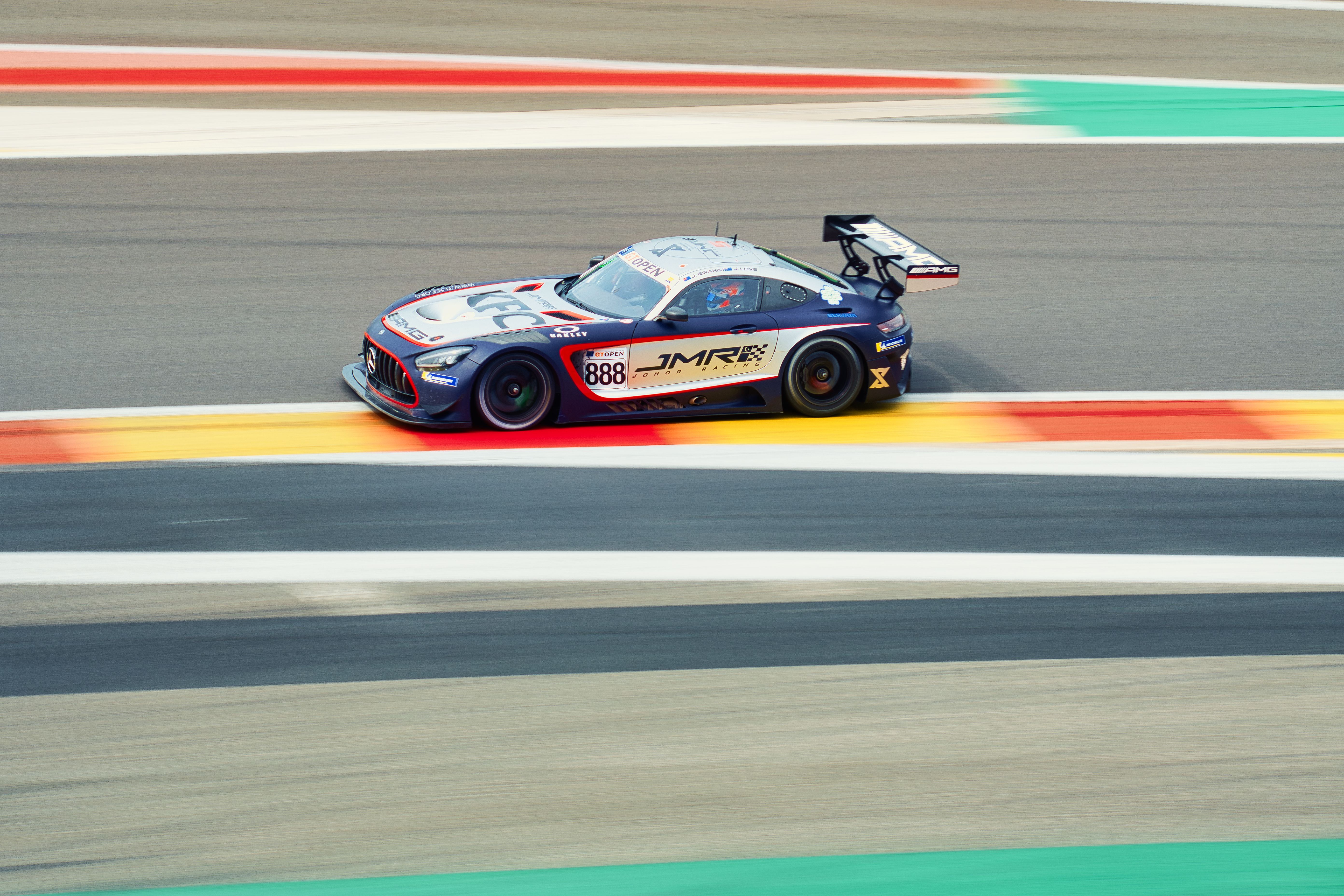 A mercedes sports car driving on a race track · Free Stock Photo