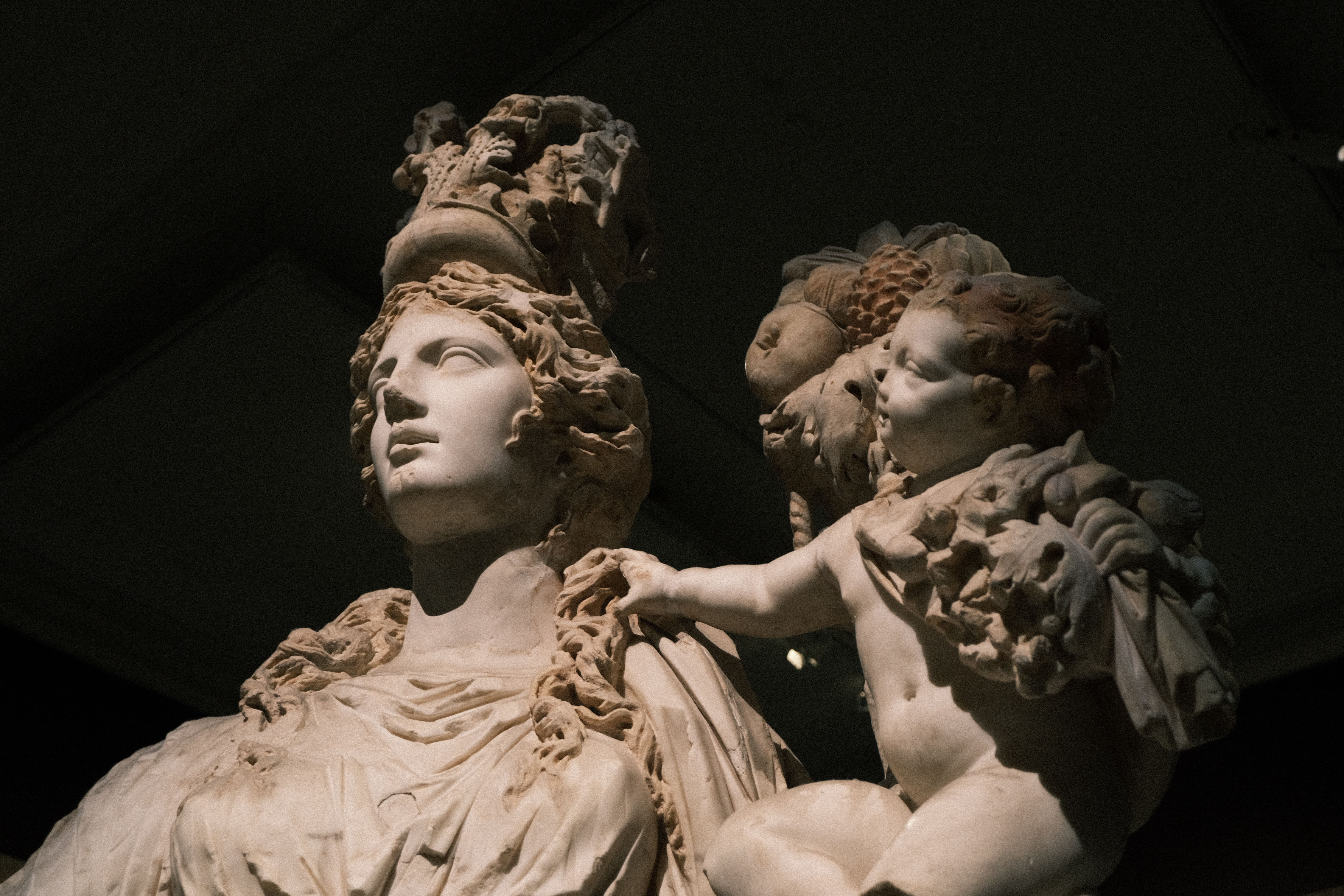 Detailed marble sculpture of goddess Tyche displayed in a museum setting.