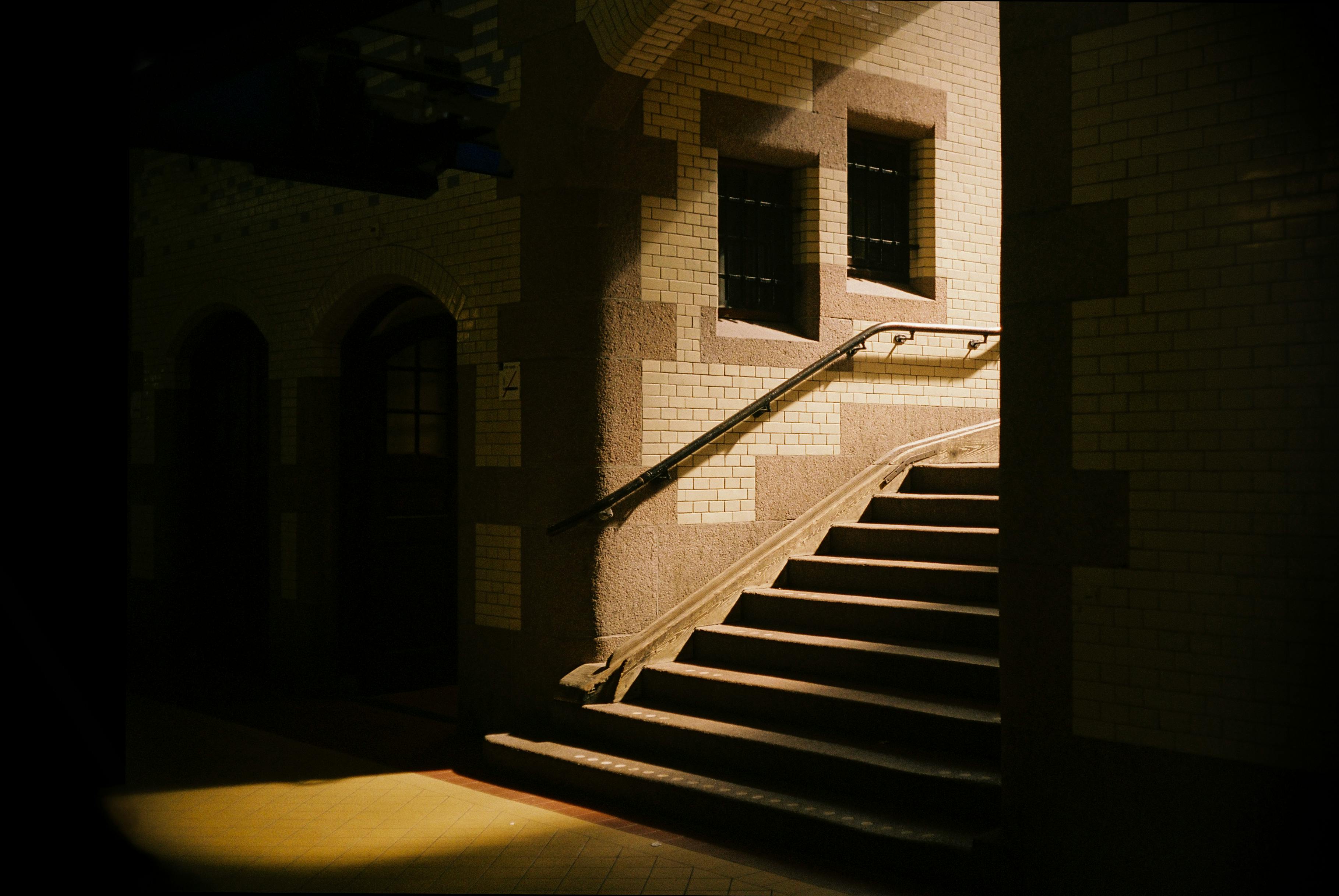 Dramatic shadows and light on a staircase inside an Amsterdam tunnel.