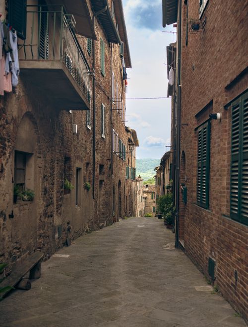 Free Explore the picturesque narrow street in Siena, Tuscany, showcasing historic architecture and rustic charm. Stock Photo