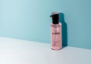 Plastic Bottle Placed on White Platform With Blue Wall