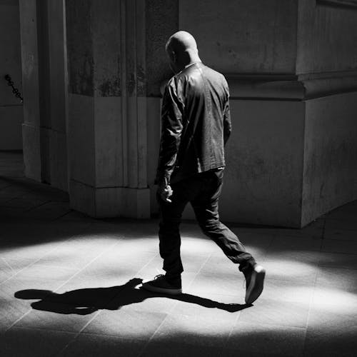 A man walking in the dark in a city