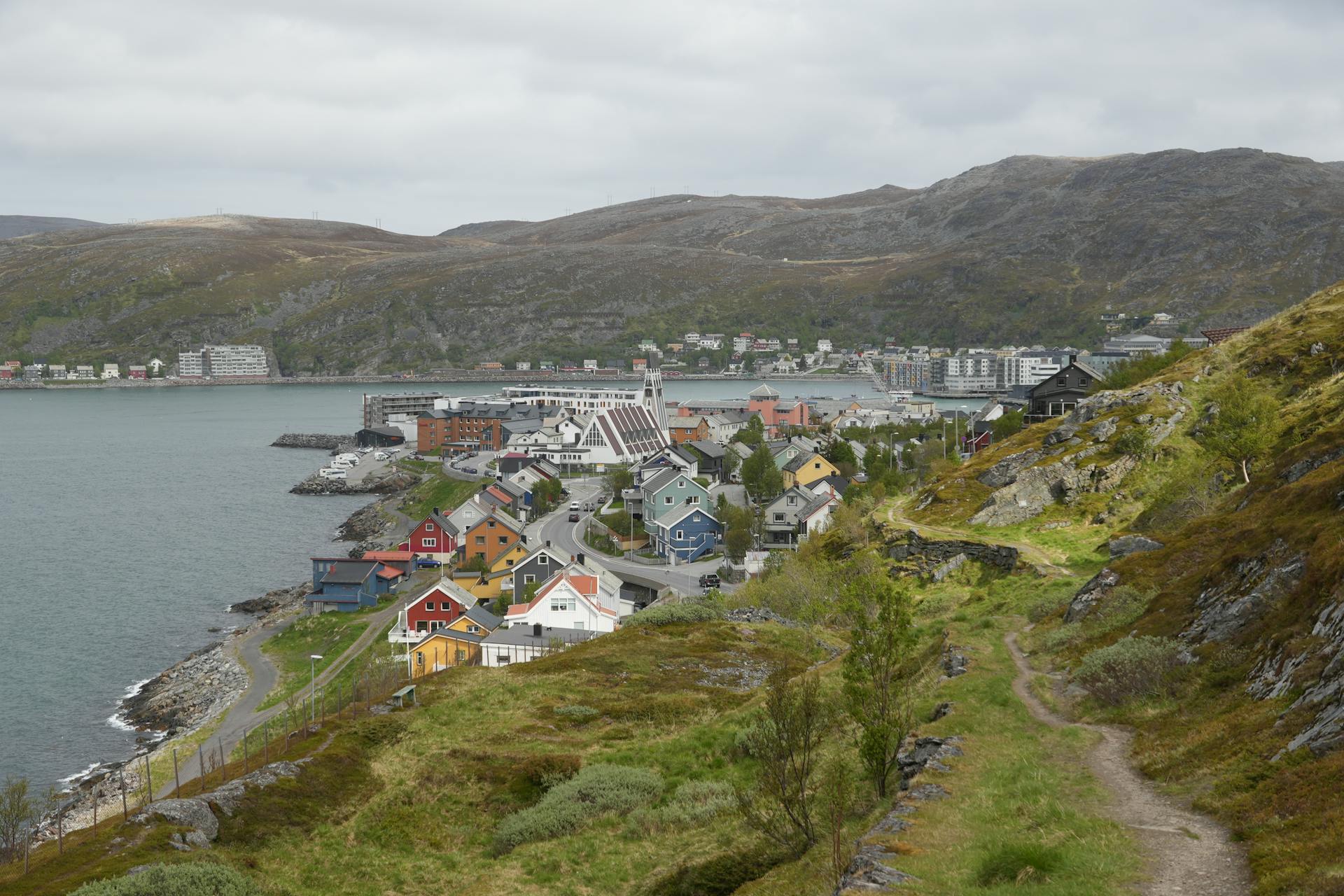 Explore the picturesque Hammerfest, Norway with charming houses along the fjord coastline.