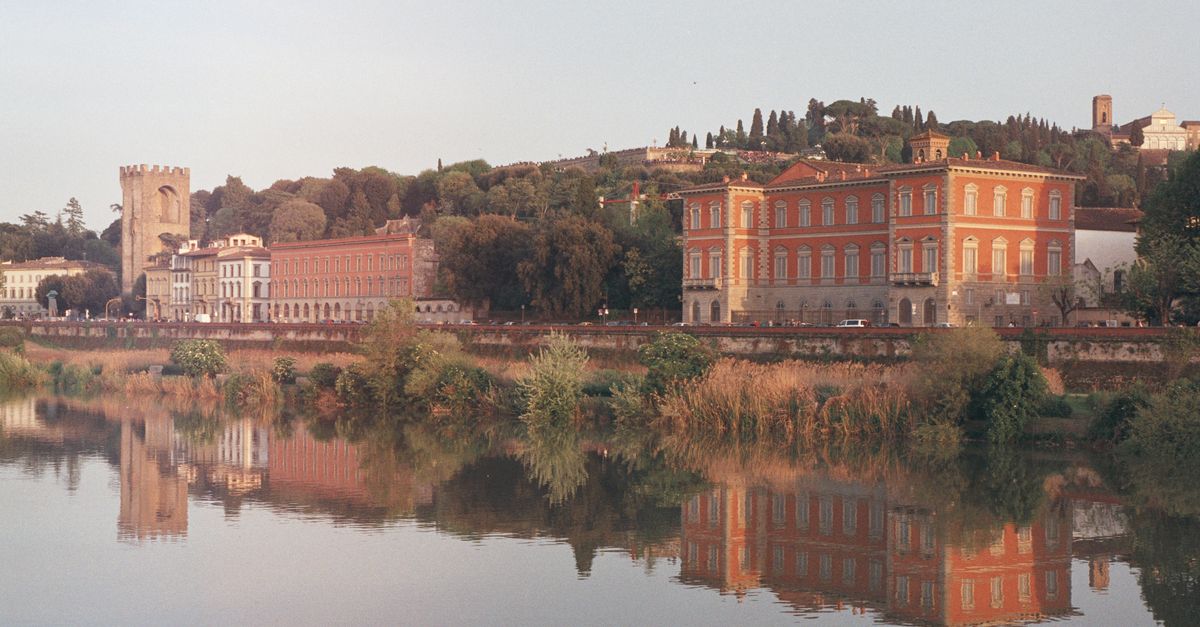Scenic view of Palazzo Serristori along the Arno River in Florence, Italy at sunset.
