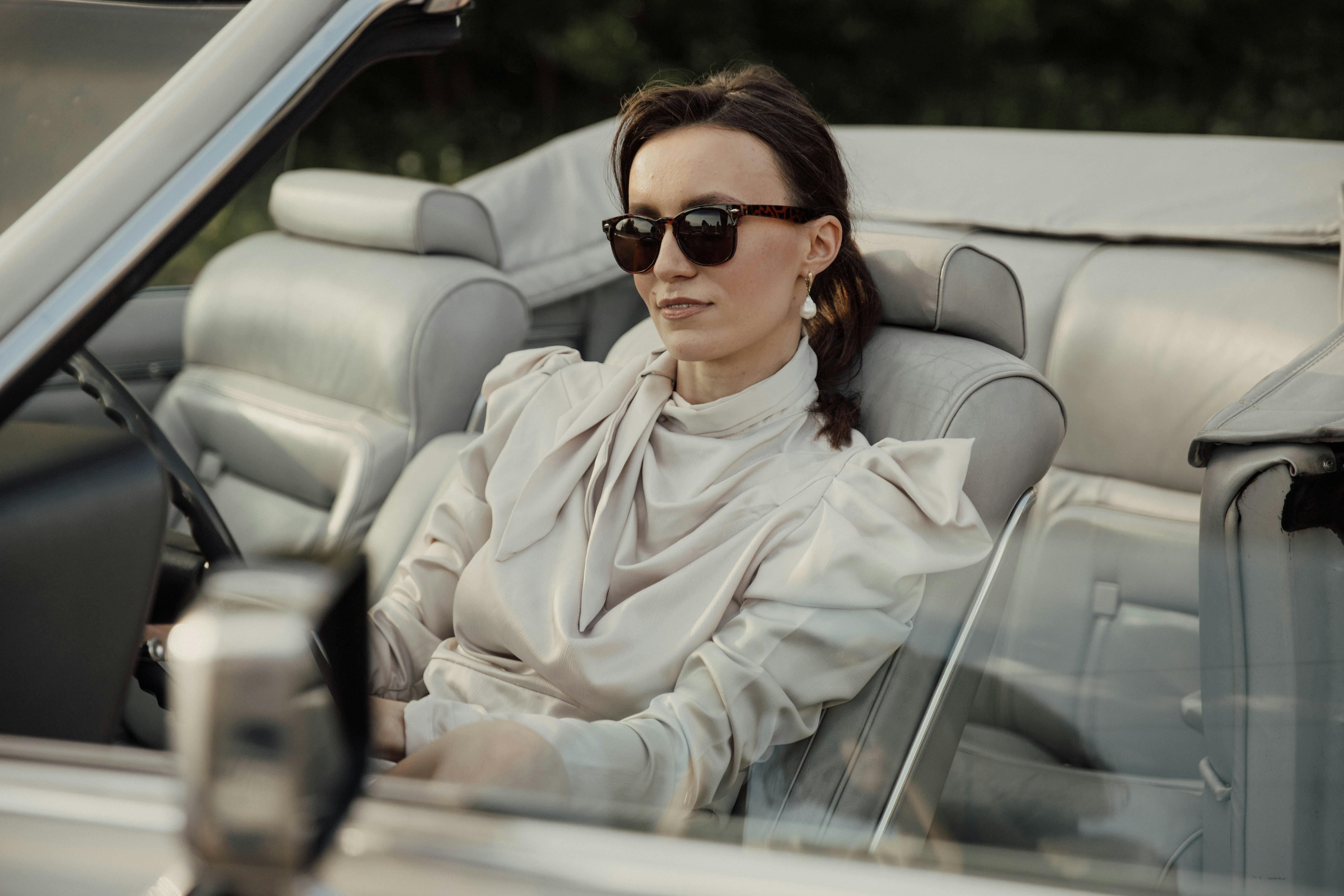 woman in sunglasses sitting in cabriolet car