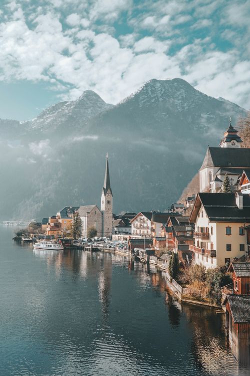 Free Picturesque Hallstatt town by the lake with stunning alpine mountains in the background. Stock Photo
