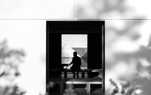 A man sitting in a chair in front of a window