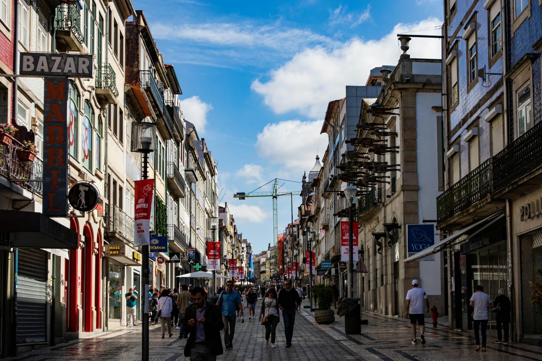 Why You Should Join My Advisers to Boost Your Financial Blog Reach 5 A lively street scene in Porto, Portugal, showcasing bustling shops and pedestrians.