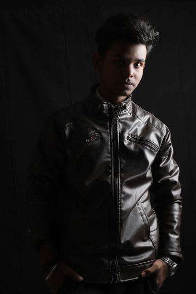 Studio portrait of an Indian man in a leather jacket