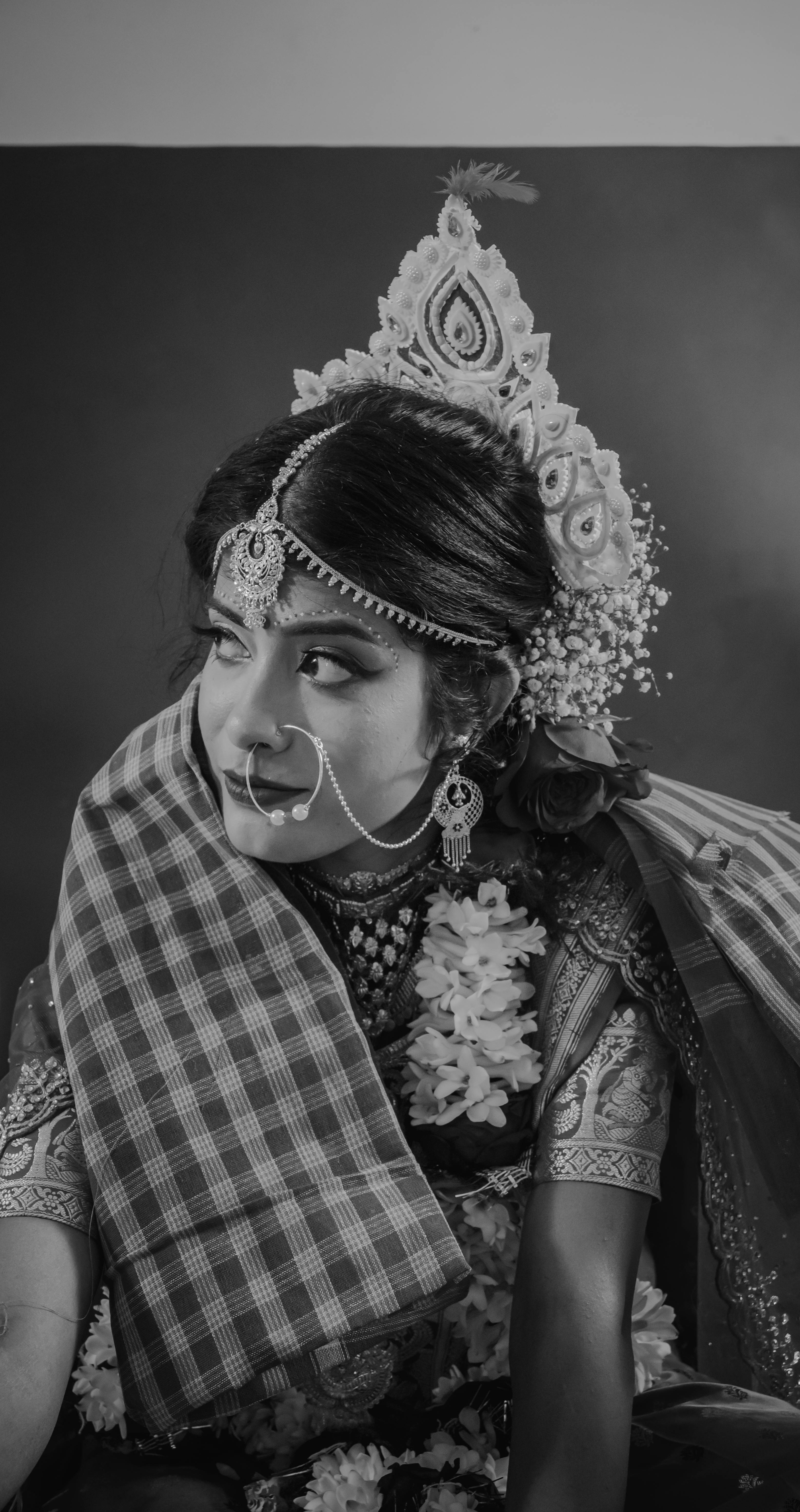 Elegant portrait of a traditional Indian bride wearing intricate jewelry and a headdress.