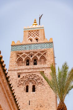 Capture of the Kutubiyya Mosque minaret with palm silhouette in Marrakech, Morocco.