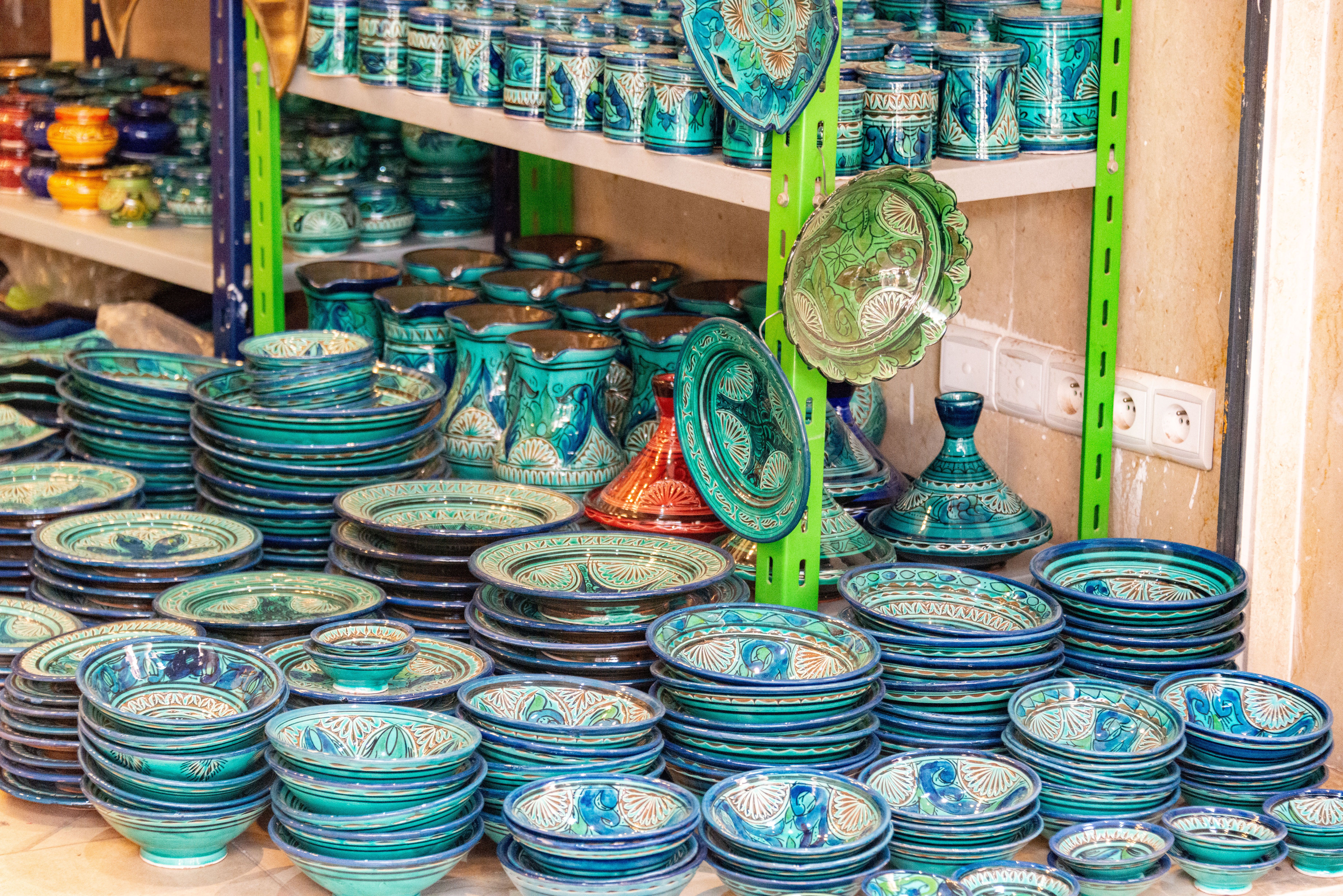 Variety of Dishes with Patterns Standing on the Ground and Shelves in a ...