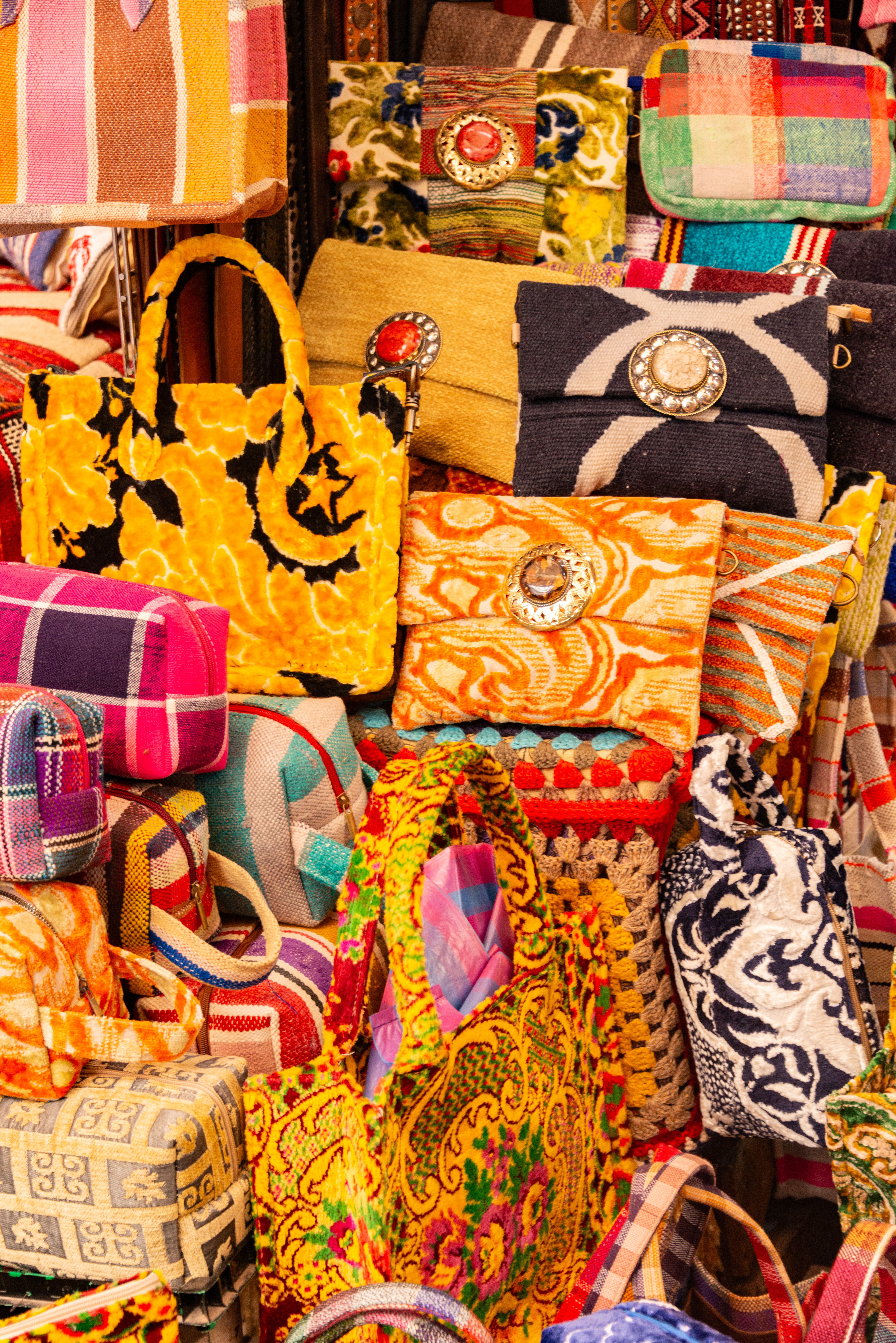 Vibrant collection of handmade handbags on display at a market, showcasing colorful patterns and textures. - Price Ranges and Budget Considerations